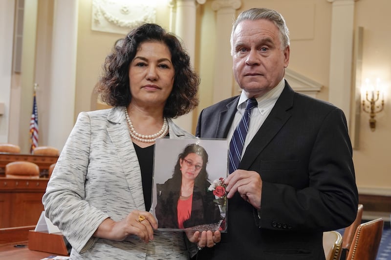 Rep. Chris Smith, R-N.J., right and Campaign for Uyghurs founder and executive director Rushan Abbas — holding a photo of her sister Gulshan Abbas who is in prison in China — pose for a photo after a hearing on China on Capitol Hill, Sept. 12, 2023, in Washington.